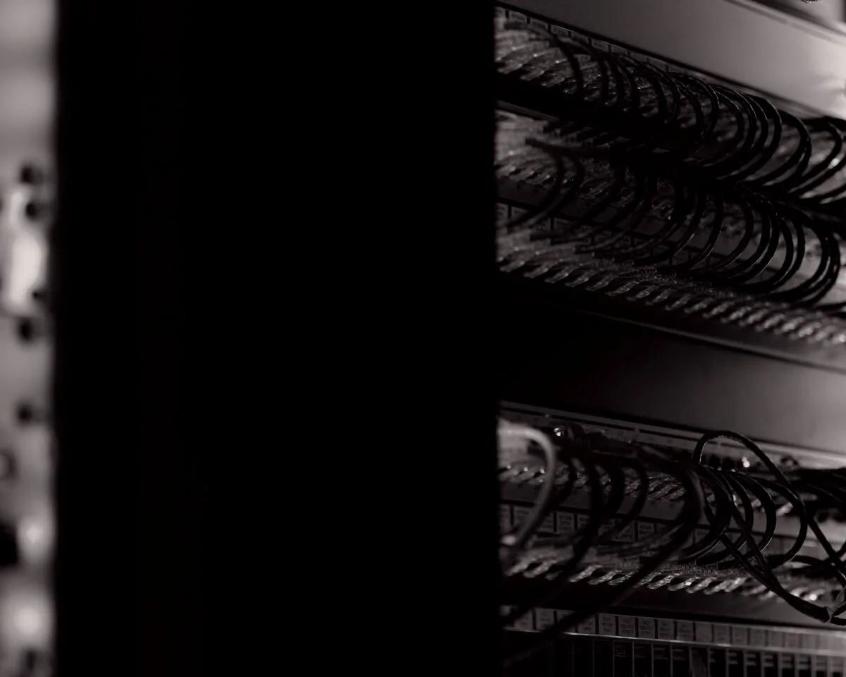 Server cabinets with patch cabling in a dark equipment room